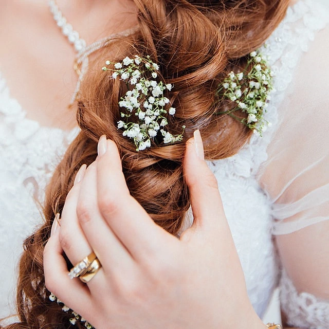 Long braided hair with white flowers